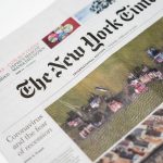 Detailed shot of New York Times newspaper featuring coronavirus and recession headline.
